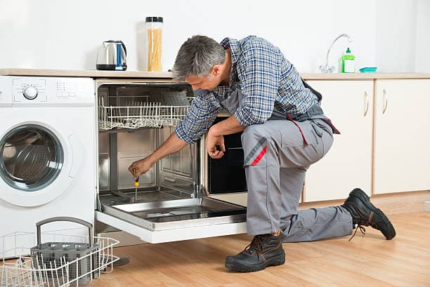 Technician repairing a washing machine